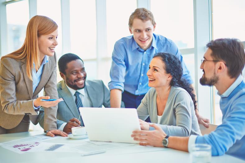 Employees happily working together as the are resocialized at the office